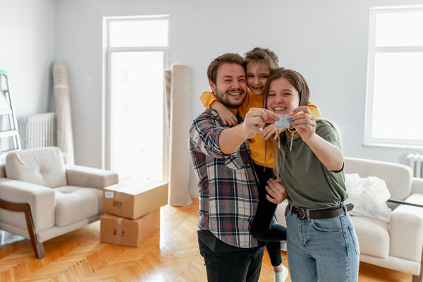 Family holding keys to new home