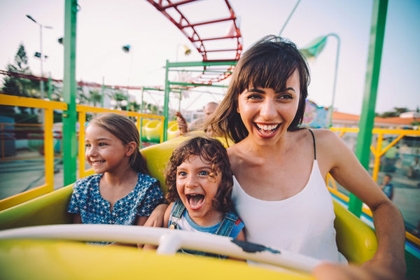 Mom with son and daughter on rollercoaster