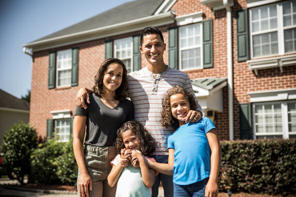 Family standing outside of their home