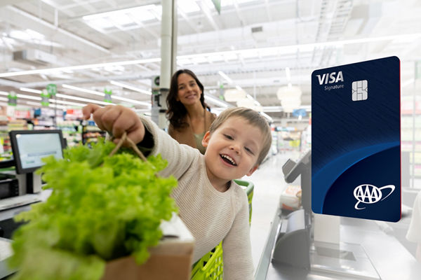 Mom and son grocery shopping with AAA Daily Advantage Visa credit card