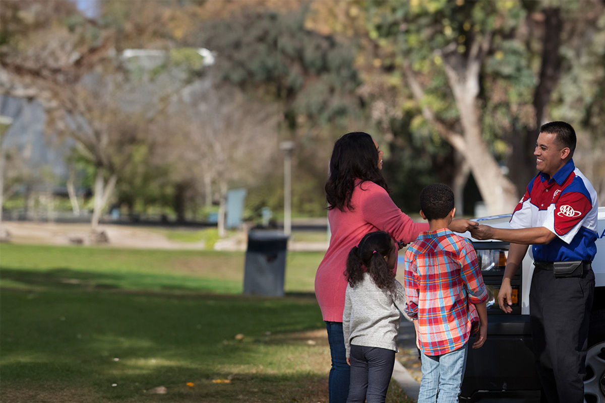 AAA Roadside Assistance driver helping a family.